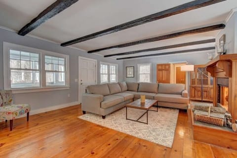 This living room has an oversized sectional with a large fireplace and smart TV.