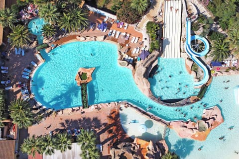 Aerial view of a vibrant water park, featuring winding slides and multiple pools for endless fun.