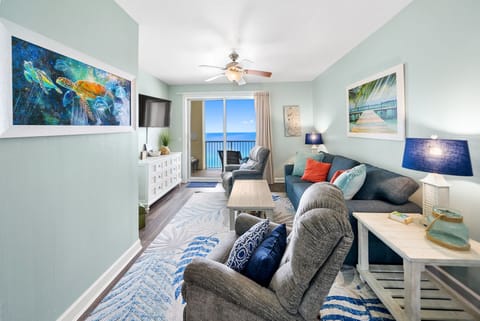 Unwind in this bright coastal living room where ocean-themed art and plush seating create your perfect seaside retreat.