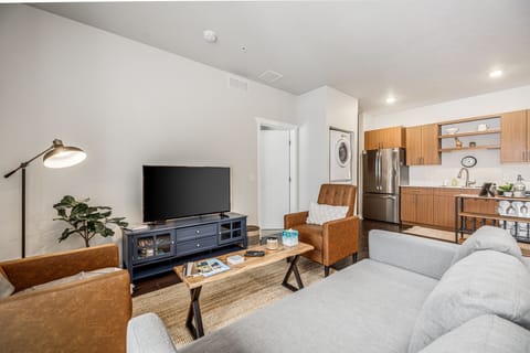 Inviting lounge space w/ comfy seating, TV & seamless flow into the kitchen