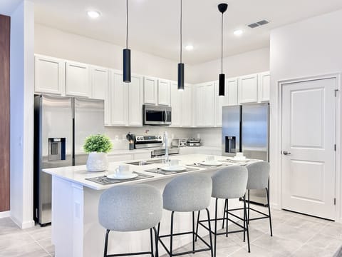 Large kitchen with stainless steel appliances.