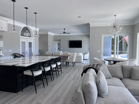 Kitchen meant for entertaining Open area for living room, kitchen opening to expansive back patio with inground pool and hot tub