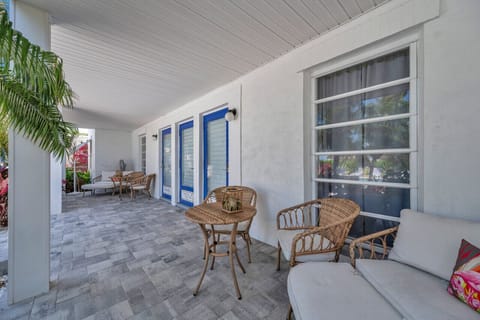 Covered outdoor dining area w/ wicker seating, great for relaxed meals in the fresh air.
