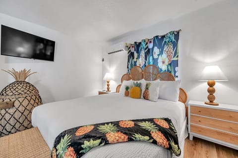 Comfortable bed dressed in crisp linens & playful decor for a restful night’s sleep.