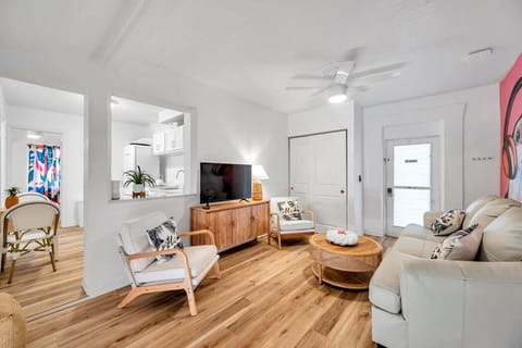 Bright living room w/ cozy seating & stylish decor, ideal for relaxing after a full day out.