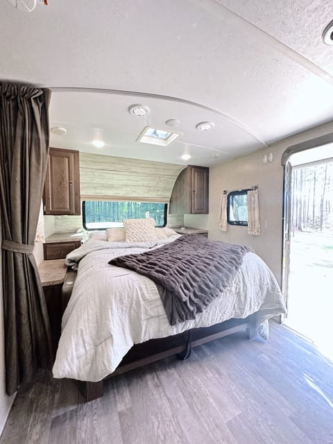Unwind in a peaceful queen bed retreat with calming views of nature. 
