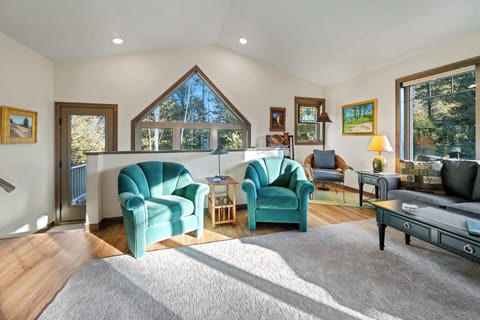 Living room area includes multiple seating areas and a Smart TV