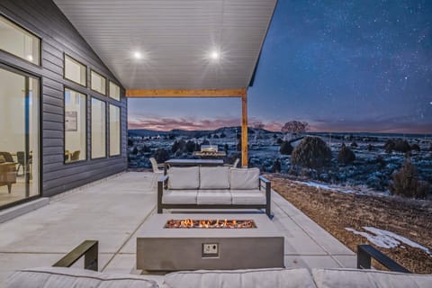 Bask in the warmth of the fire pit while star gazing on the back patio
