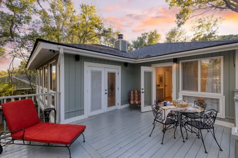 Outdoor deck with lounge space and a dining table.