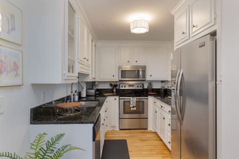 Kitchen is fully equipped and features stainless steel appliances.