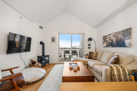 Living room with a Smart TV with cable, a variety of board games, an electric fireplace and a cozy couch to kick back after a day of adventures.