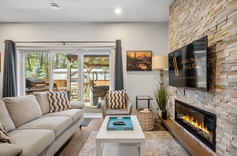 Living room with a Smart TV, a variety of board games, an electric fireplace and a cozy couch to kick back after a day of adventures.