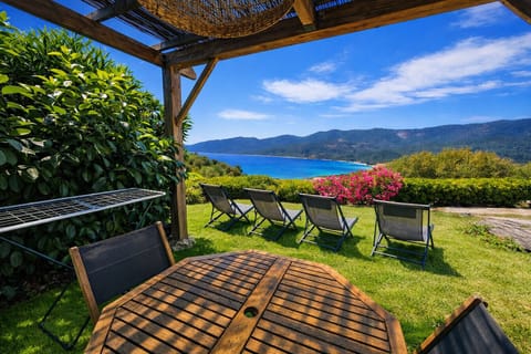 Terrace with a view of the sea, complete with furniture and a pergola