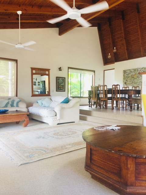 Open plan lounge dining with raked ceiling and fans