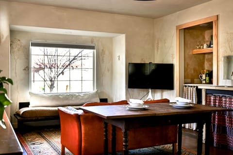 The Vintage Leather Couch, Smart TV, Large Picture Window create a relaxing ambiance.