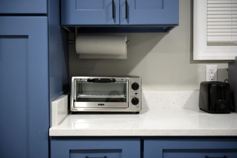 A toaster and toaster oven are included in the kitchen supplies.