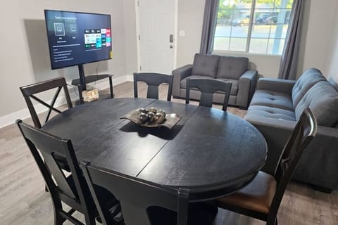 The breakfast/dining area, along with the living room and the 65'' TV for your entertainment