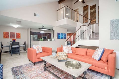 Bright and inviting open-concept living area with modern décor, comfortable seating, and easy flow into the dining and kitchen spaces—perfect for relaxing or entertaining.