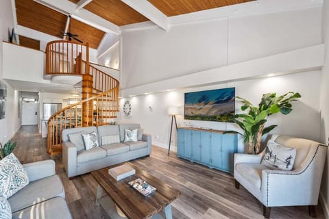 A bright, stylish living room featuring a cozy sofa, modern décor, and an inviting open layout perfect for relaxing after island adventures.