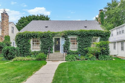 Charming ivy-covered cottage with lush gardens and peaceful residential setting creates a perfect retreat.