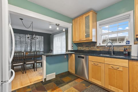 Your bright kitchen flows into the dining area, perfect for preparing meals and gathering together.