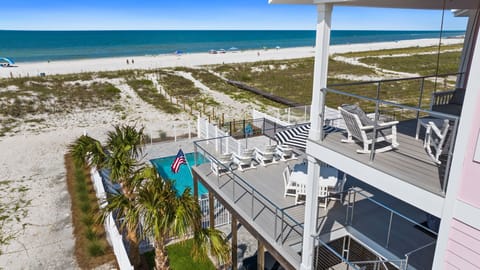 Beachfront property featuring multilevel decks overlooking white sand beaches and turquoise waters of the Gulf Coast. Ideal location for seaside getaways with direct beach access and coastal views.