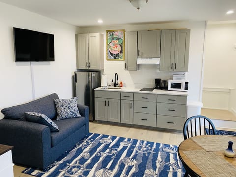 kitchenette with electric stove top, fridge, microwave, kettle, espresso machine