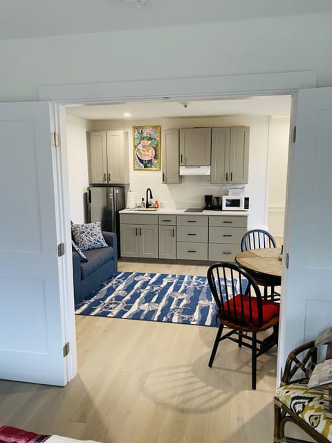 kitchenette with electric stove top, fridge, microwave, kettle, coffee maker