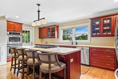 Chef’s kitchen with bar seating and full modern amenities.
