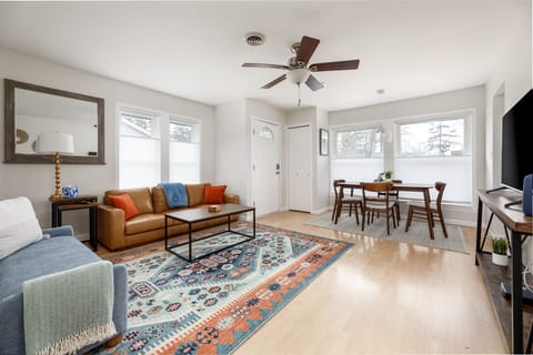 Enter our cozy living room, bathed in natural light from two large windows. Sink into the plush couch and unwind with TV entertainment in an elegant yet inviting ambiance.