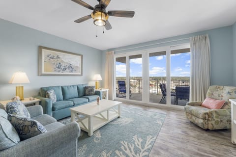 Relax in this coastal-inspired living room with balcony access and ocean views.