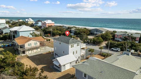 Coastal community featuring beachfront homes with ocean access and sandy shores nearby.