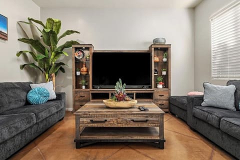 Elegance meets depth in our dark wood-themed living room, where two sofa sets create a rich and inviting atmosphere