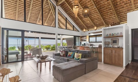 Bright open living area with tropical views.