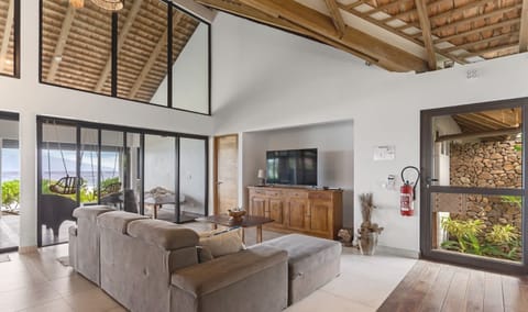 Bright open-plan living room with vaulted wooden ceiling.