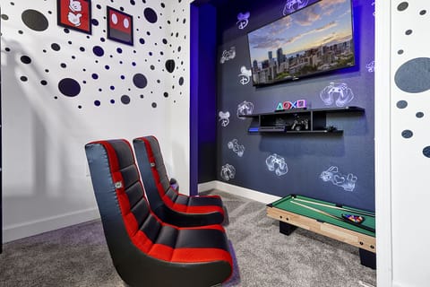 Level up your vacation with our vibrant gaming nook, complete with plush racing seats, cutting-edge console wall, and a mini pool table. It's the ultimate play zone for every gaming enthusiast's dream stay.