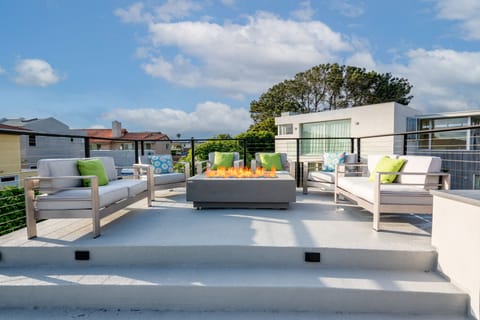 Full furnished roof top deck - seating, firepit, umbrella, and kitchenette.