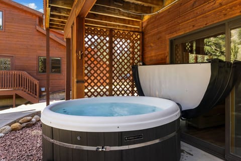 Soak in your private hot tub surrounded by warm wood and natural privacy screens.
