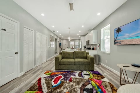 The focal point of the room is a sumptuous sofa, inviting you to sink into its plush cushions and unwind after a long day.