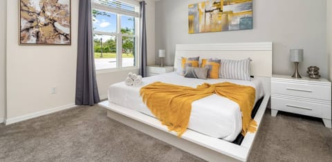 Spacious master bedroom with a luxurious king bed, a private bathroom, and a TV for ultimate comfort.