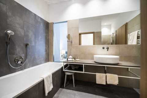 Deluxe Suite | Bathroom | Designer toiletries, hair dryer, bathrobes, slippers