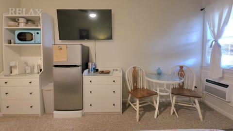 Studio includes a small dining nook. Mid-size fridge.
