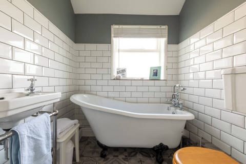 High top bath with shower attachment upstairs