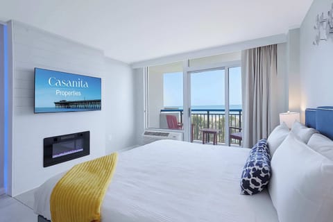 Binge your favorite shows by the glow of a sleek LED fireplace—with balcony views just steps away. It's cozy, coastal, and exactly the kind of vibe you didn’t know you needed.
