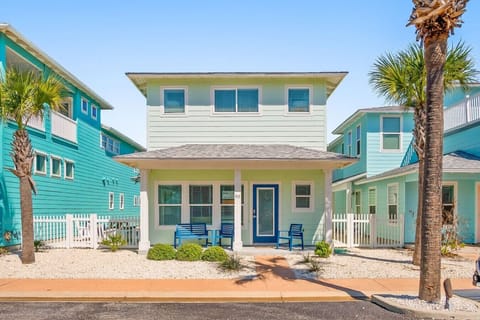 Charming beach cottage with porch swings and palm trees!