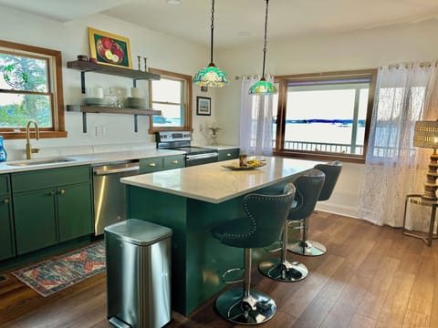 Kitchen island in main house with three stools