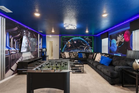 Epic Star Wars-themed game room with foosball, LED lights, and huge sectional.