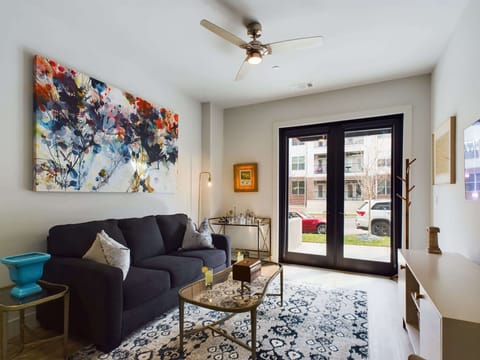 Bright living room with comfortable seating, pull out sofa, smart TV, complete with designer decor.
