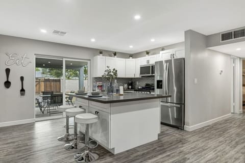 Spacious kitchen with island bar seating three people