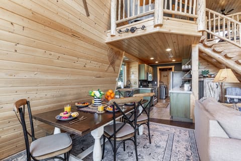 Gather around the farmhouse table for meals and memories in this cozy open space. Rustic wood finishes, a nearby kitchen, and comfy seating make it the perfect place to start your Yellowstone adventures or relax after a day outdoors.